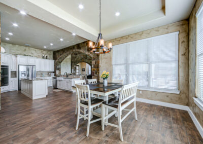 Symmetrical design layout between kitchen, dining, and great room in Floresville Texas custom home.