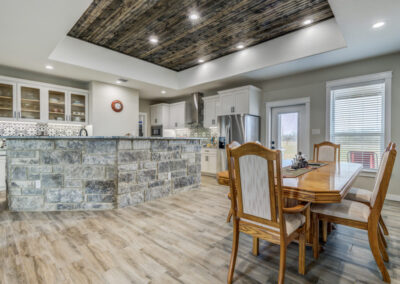 Custom wood ceiling accent, granite stonework and Spanish tile in custom Texas home.