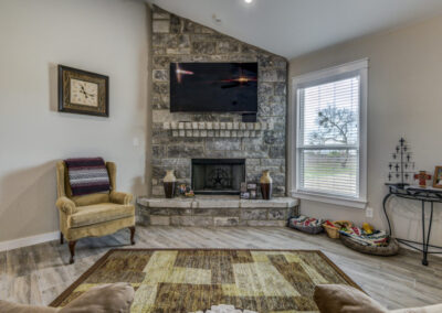 Living room fireplace in custom Texas home.
